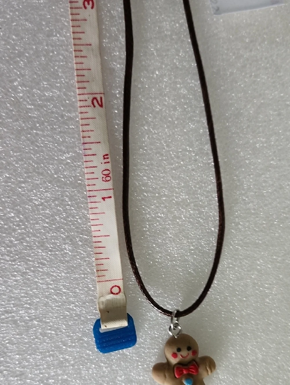 Hand Crafted Brown Gingerbread Man Necklace with Red and Blue Accents